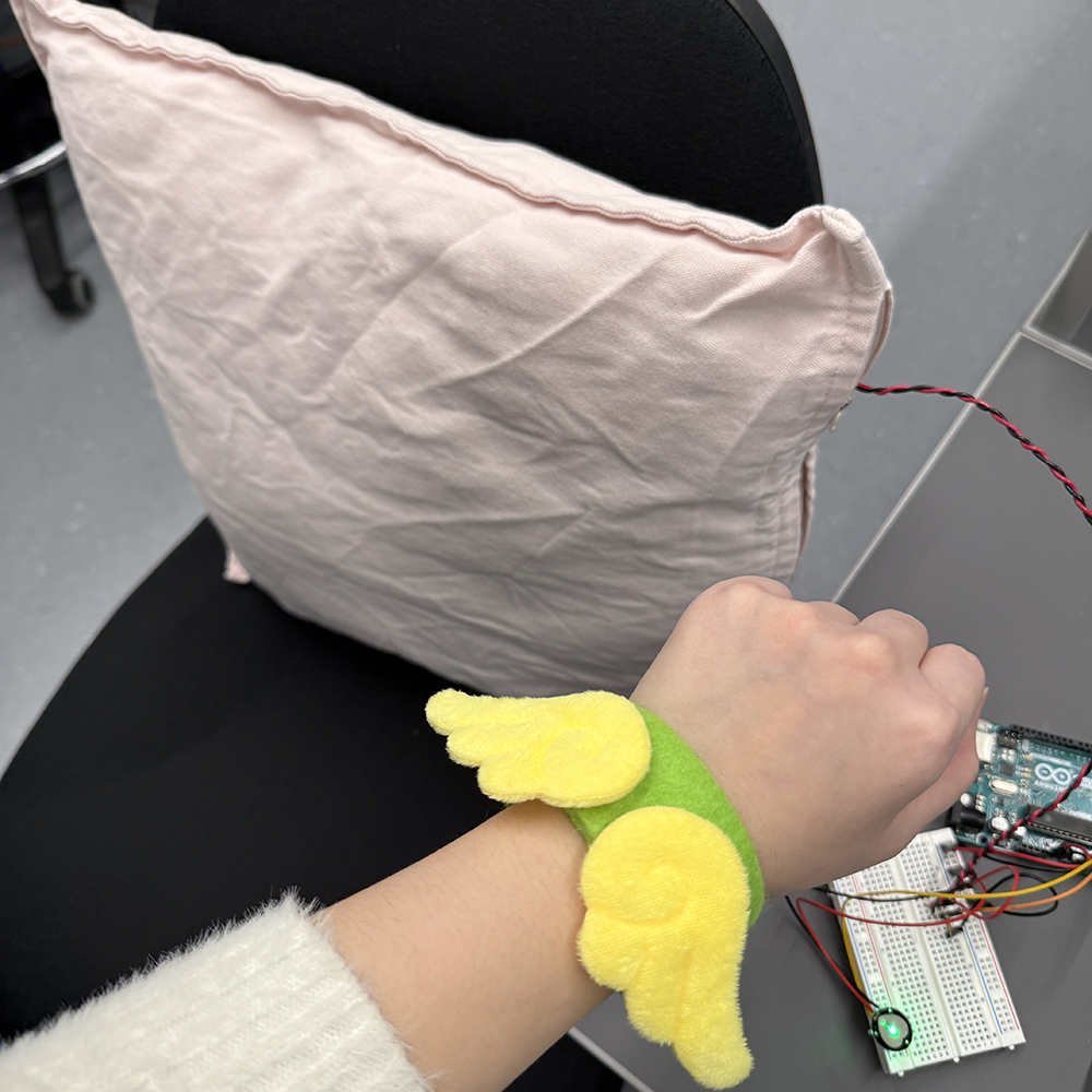 This shows how we wear the wrist band, by putting the pulse sensor in the inner part of the wrist band by touching the user and read data through wrist,