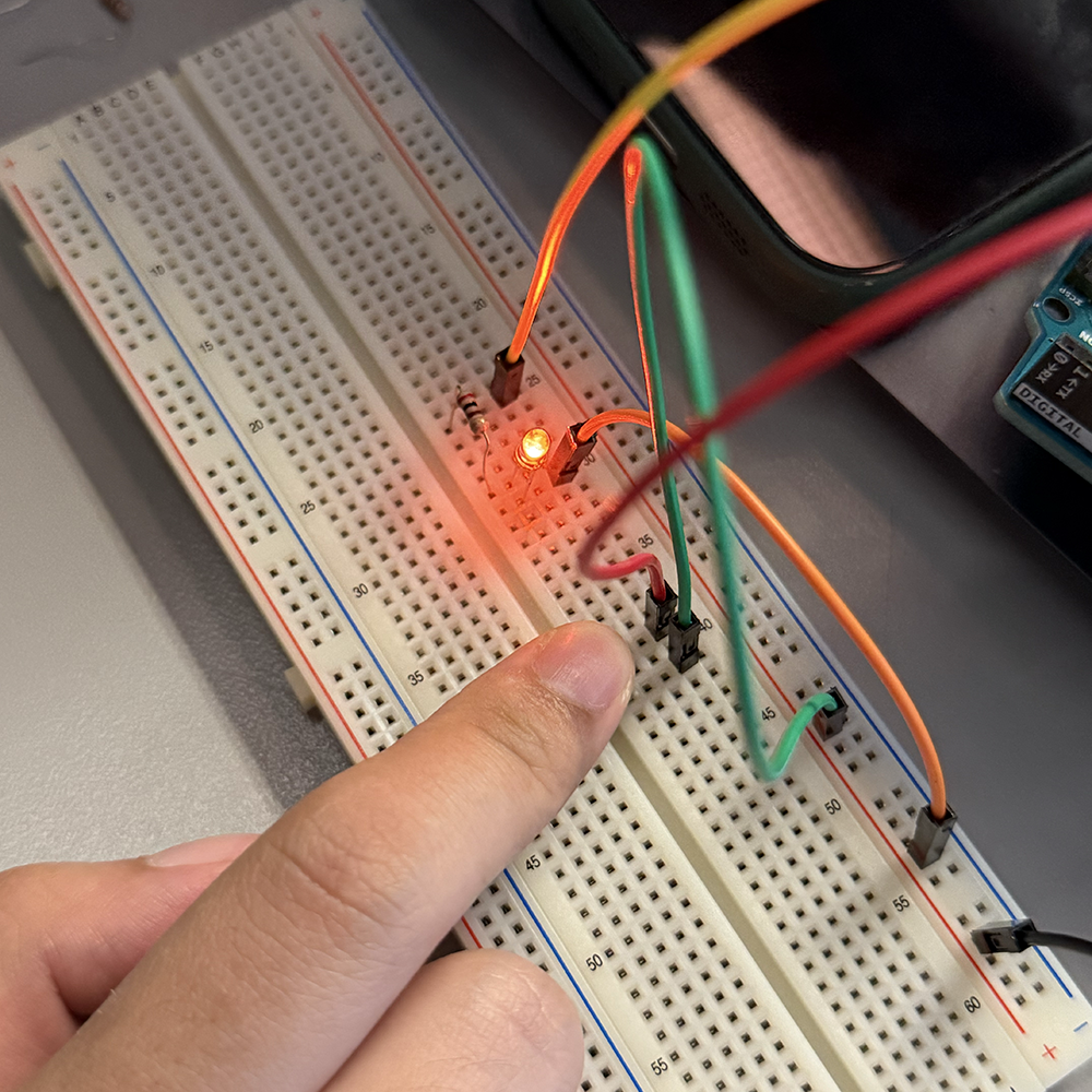 Adding one button onto the kit, and edit the code to make the light bulb shine when pressing the button.